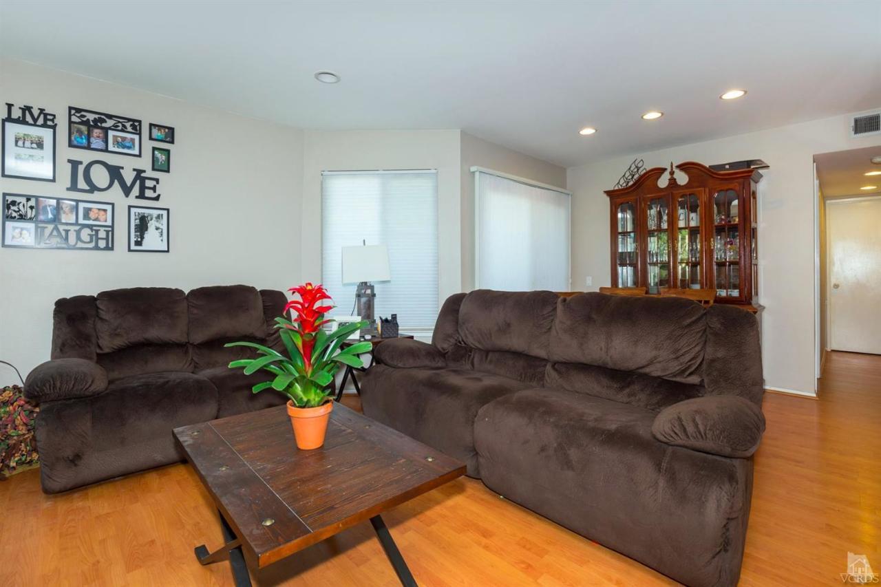 1706 Sinaloa Road, Unit 107 Simi Valley, CA 93065 - Photo 12 of 27 a living room with furniture flowerpot and wooden floor