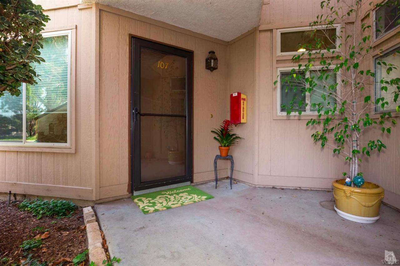 1706 Sinaloa Road, Unit 107 Simi Valley, CA 93065 - Photo 3 of 27 a potted plant sitting in front of a house