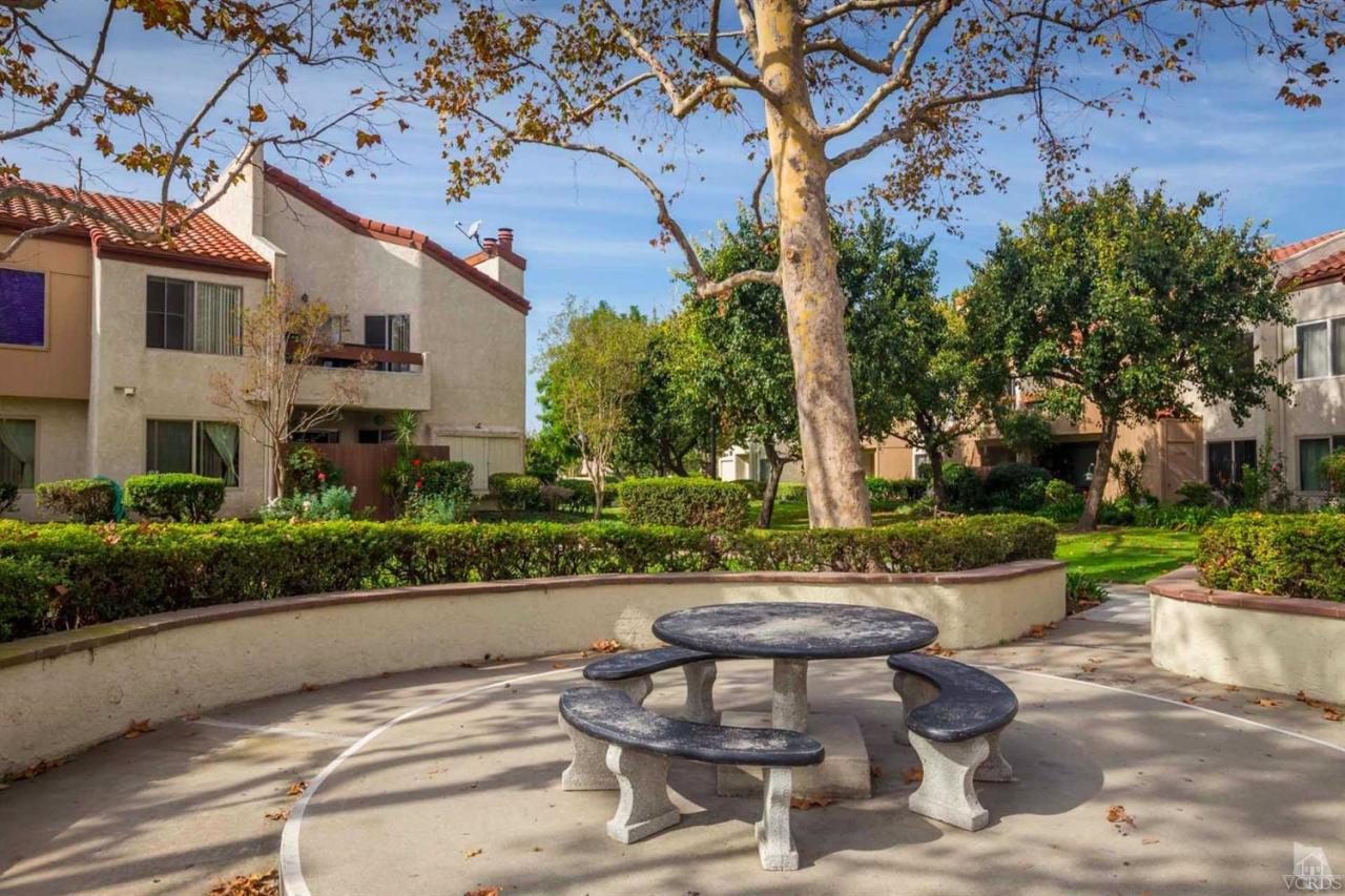 1706 Sinaloa Road, Unit 107 Simi Valley, CA 93065 - Photo 24 of 27 a view of a patio with table and chairs and potted plants