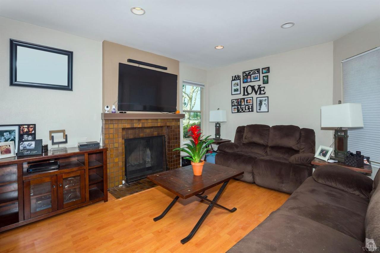 1706 Sinaloa Road, Unit 107 Simi Valley, CA 93065 - Photo 4 of 27 a living room with furniture and a fireplace