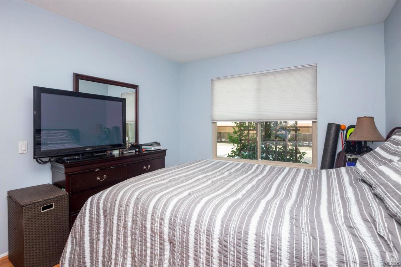 1706 Sinaloa Road, Unit 107 Simi Valley, CA 93065 - Photo 5 of 27 a bedroom with a bed and a flat tv screen on dresser