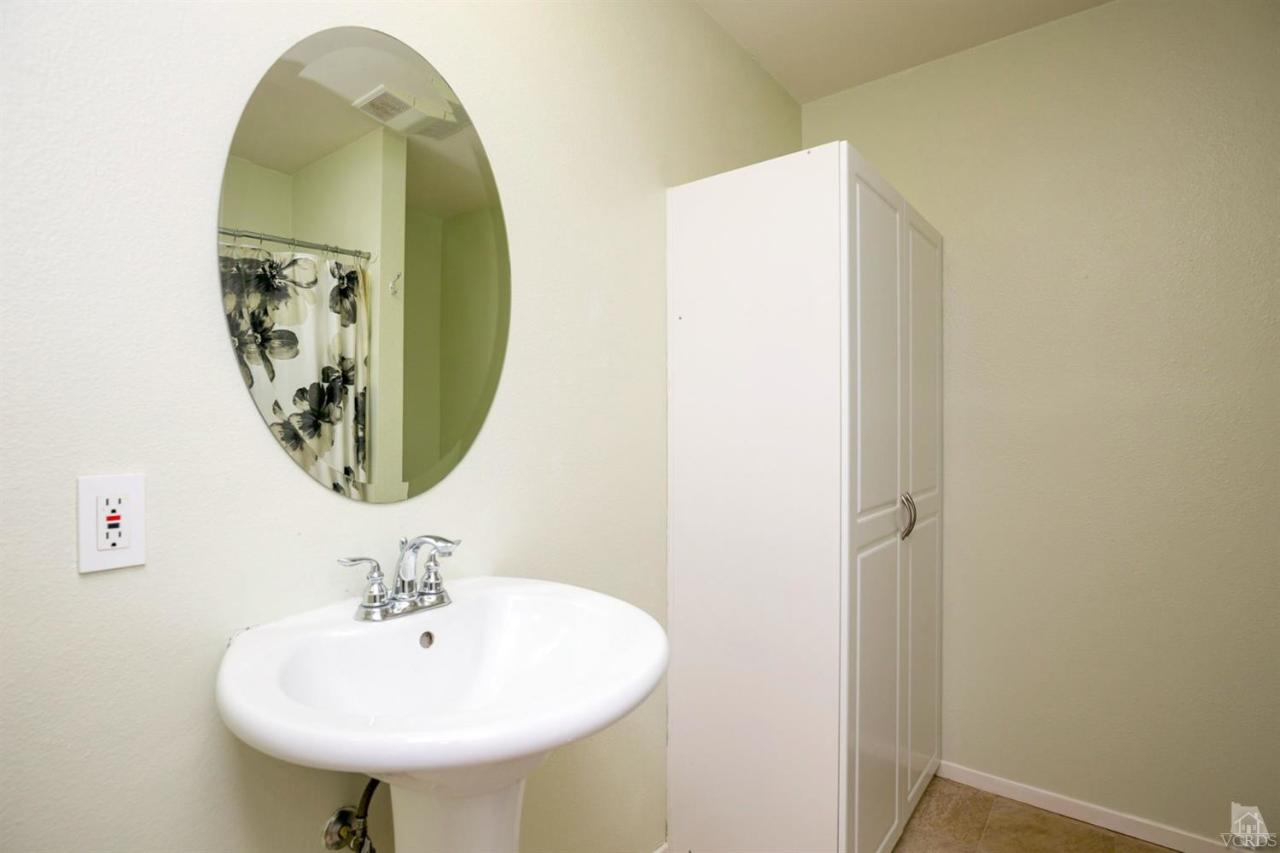 1706 Sinaloa Road, Unit 107 Simi Valley, CA 93065 - Photo 7 of 27 a bathroom with a sink and mirror