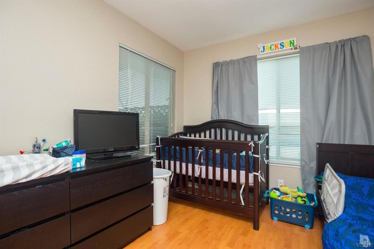 1706 Sinaloa Road, Unit 107 Simi Valley, CA 93065 - Photo 9 of 27 a bedroom with a bed and a flat screen tv