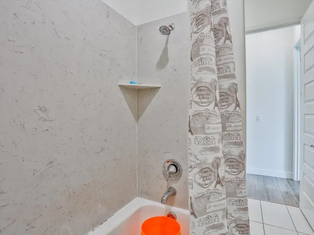 a bathroom with a shower and toilet