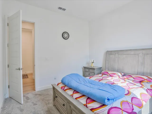 a bedroom with a bed and a lamp