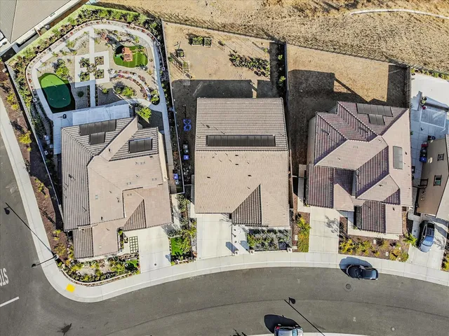 an aerial view of a house with a street