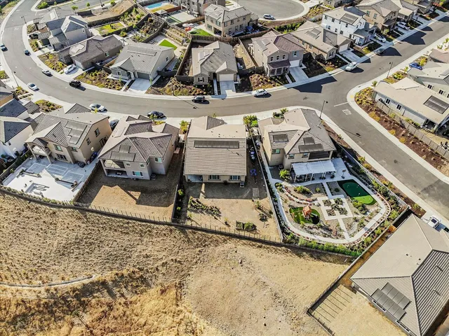 an aerial view of a backyard with a patio
