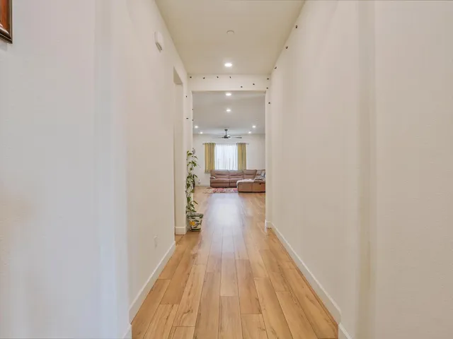 a view of a hallway with wooden floor