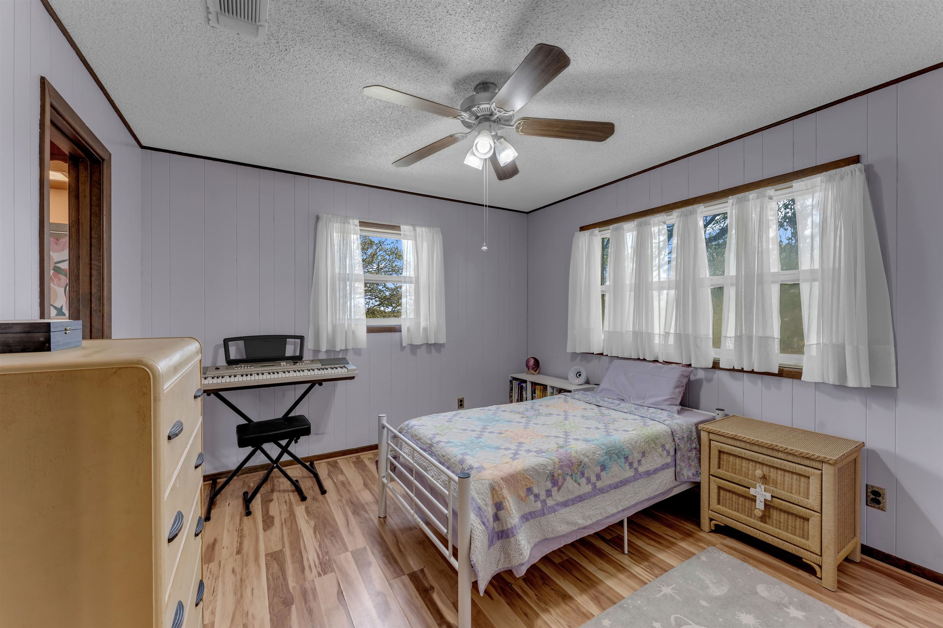 301 Wood Forest Road Kingsland, TX 78639 - Photo 15 of 32 a bedroom with a bed and a chandelier