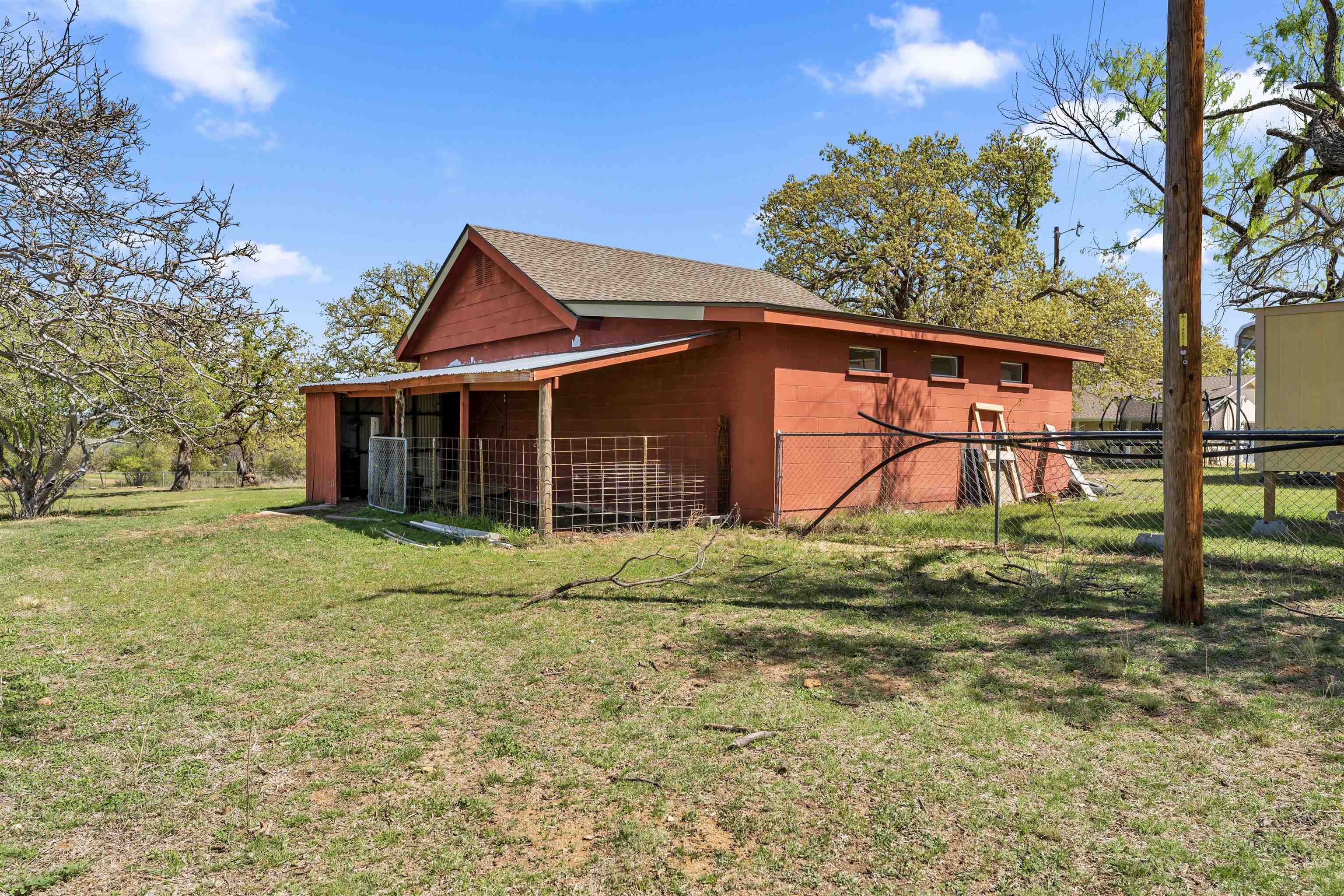 301 Wood Forest Road Kingsland, TX 78639 - Photo 25 of 32 a backyard of a house with lots of green space