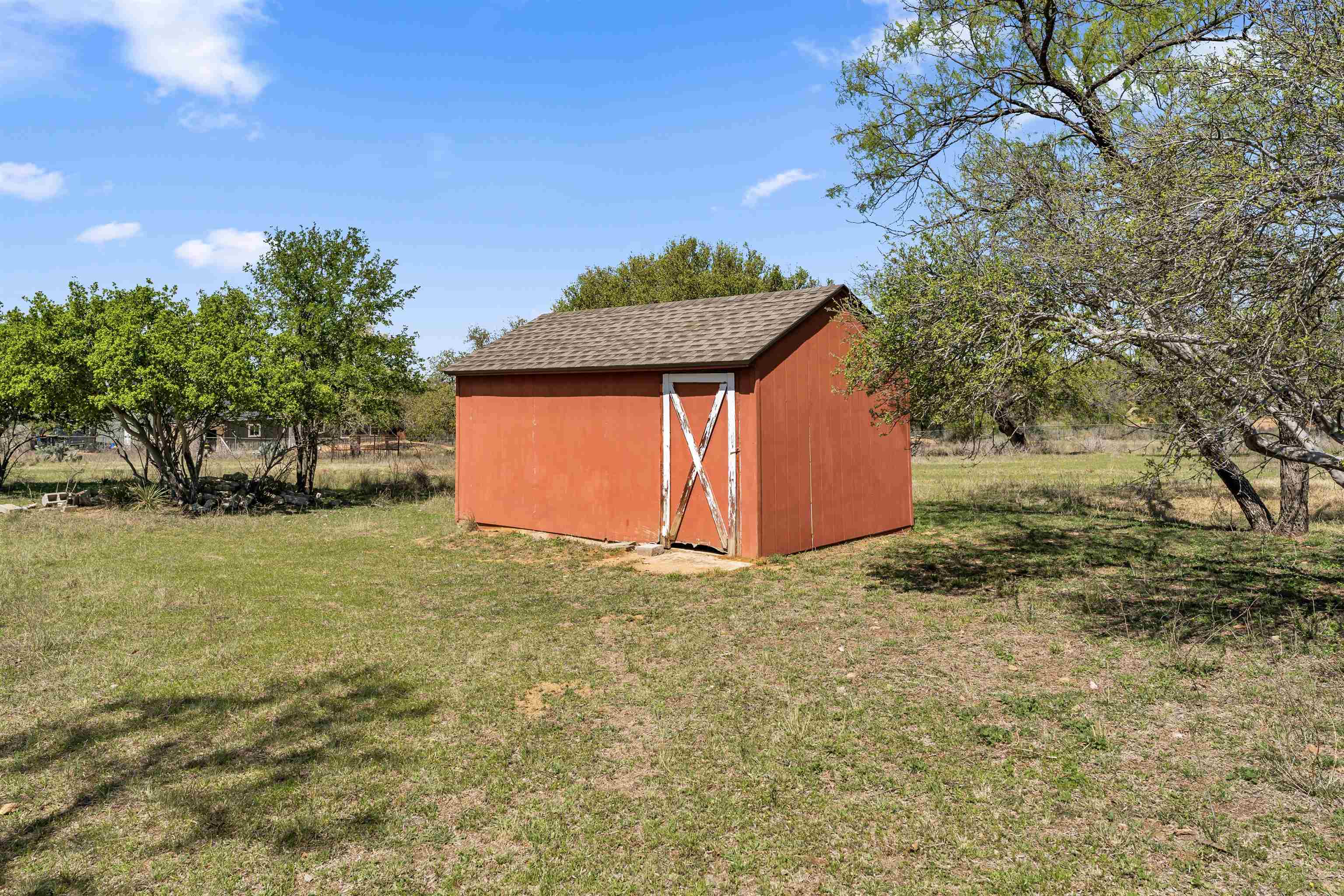 301 Wood Forest Road Kingsland, TX 78639 - Photo 28 of 32 a house with trees in front of it