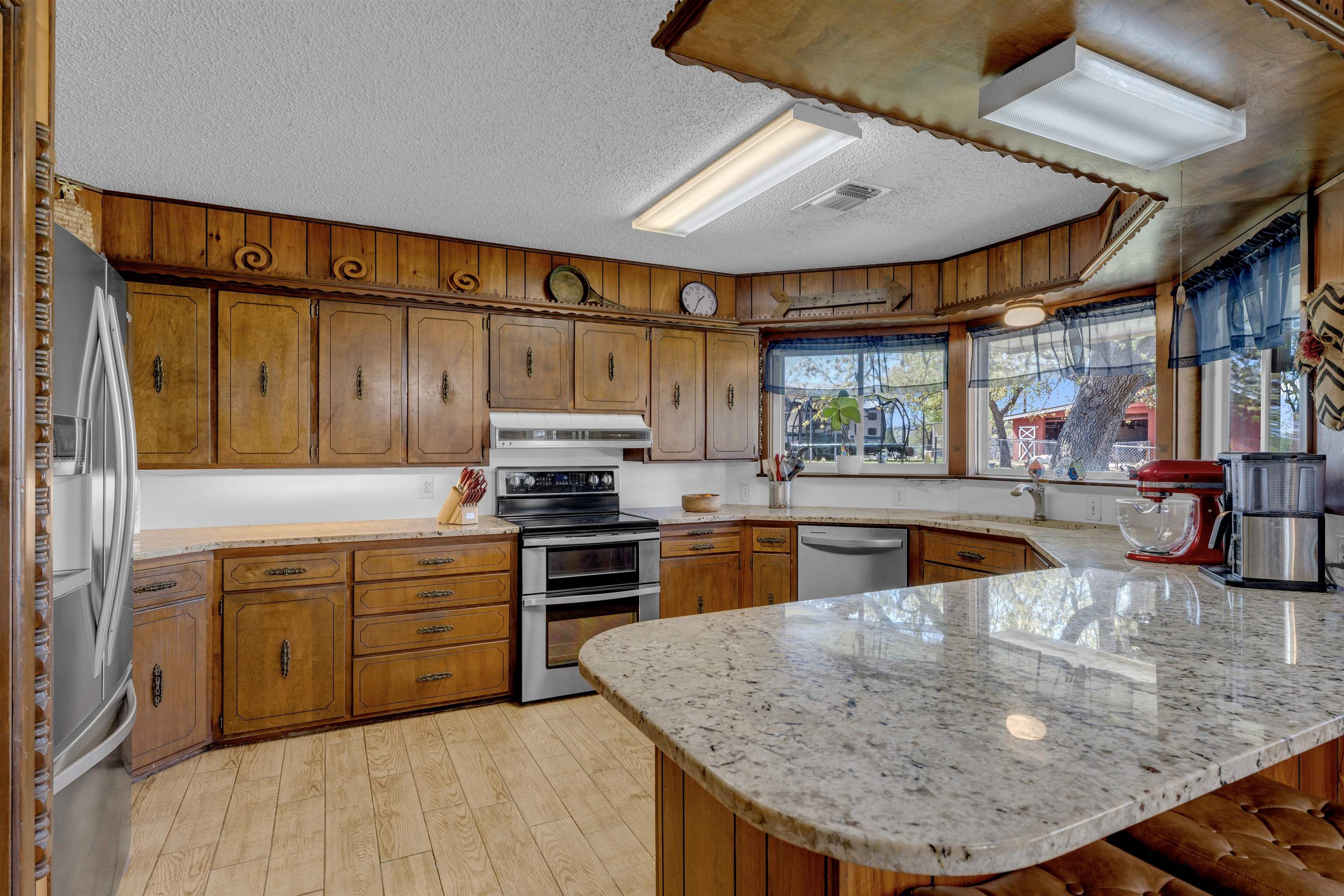 301 Wood Forest Road Kingsland, TX 78639 - Photo 10 of 32 a kitchen with stainless steel appliances granite countertop a sink a stove and a wooden cabinets
