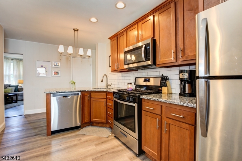 46 Hazelwood Road Bloomfield, NJ 07003 - Photo 1 of 14 a kitchen with stainless steel appliances granite countertop a refrigerator stove a sink and a microwave