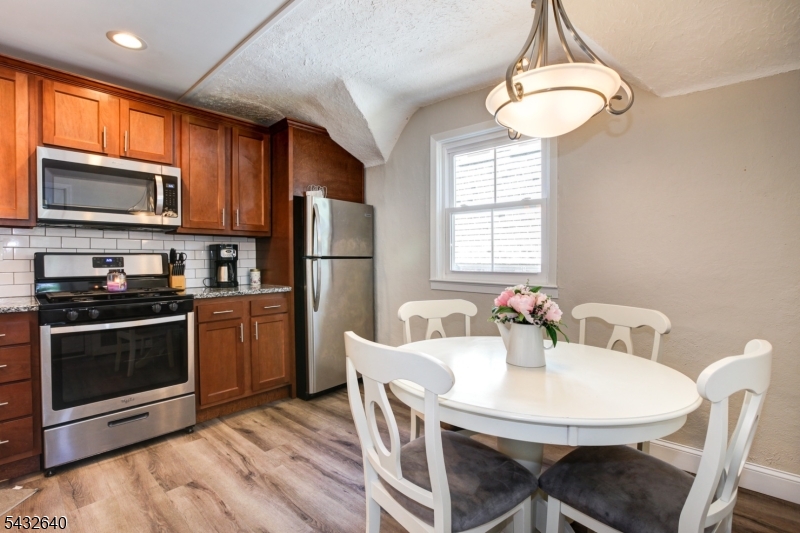 46 Hazelwood Road Bloomfield, NJ 07003 - Photo 2 of 14 a kitchen with refrigerator cabinets a sink and a stove