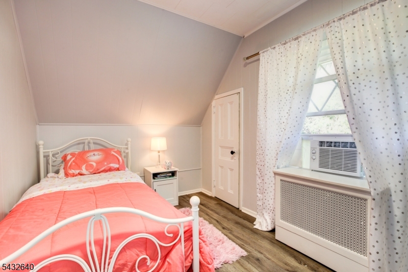 46 Hazelwood Road Bloomfield, NJ 07003 - Photo 10 of 14 a bedroom with a bed and a large window