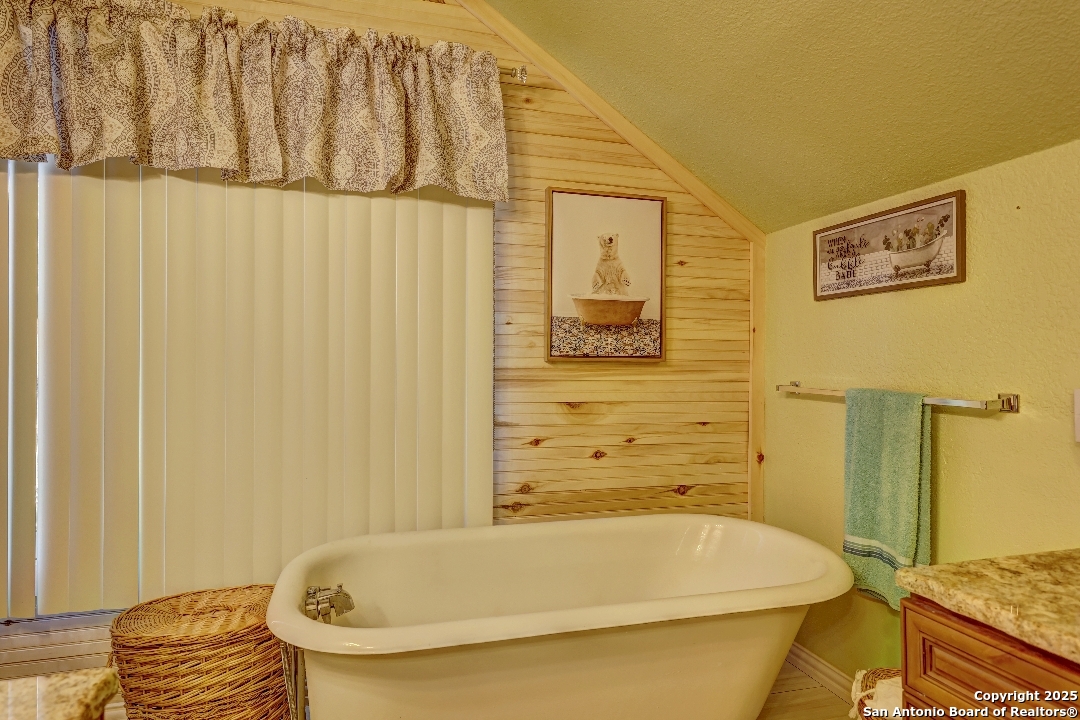 101 North 11th Street Junction, TX 76849 - Photo 15 of 26 a bathroom with a tub and shower