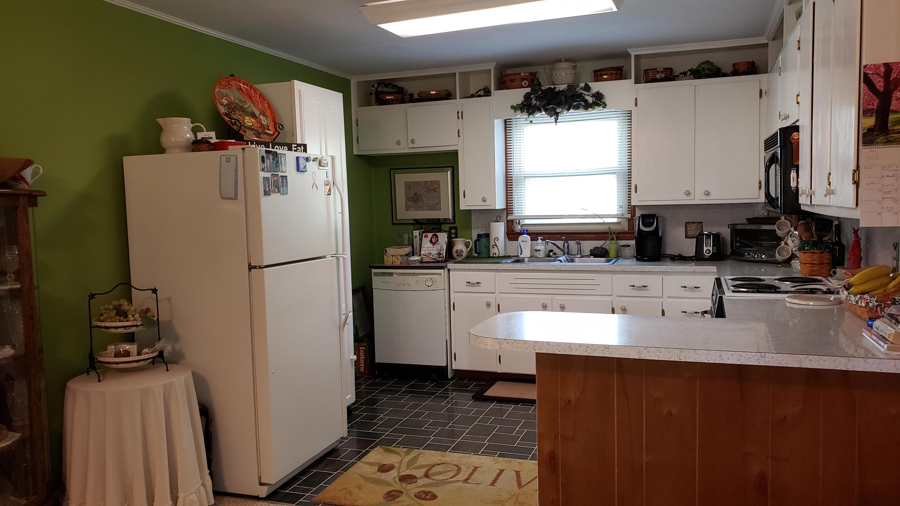 240 Highfield Road Rocky Mount, VA 24151 - Photo 3 of 20 a kitchen with sink a refrigerator and a stove