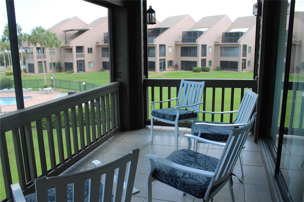 335 Windrush Loop, Unit 335 Tarpon Springs, FL 34689 - Photo 6 of 18 a view of a balcony with two chairs and a yard