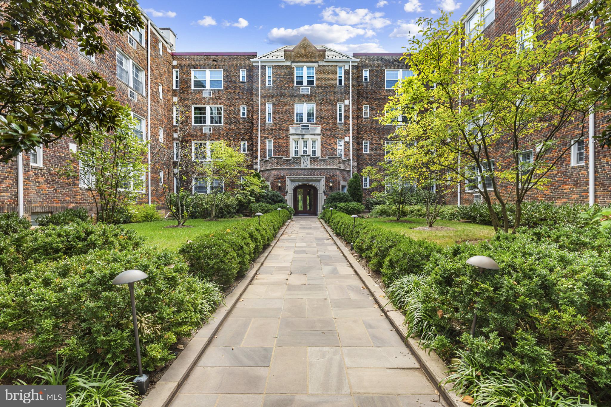a view of a brick house with a yard