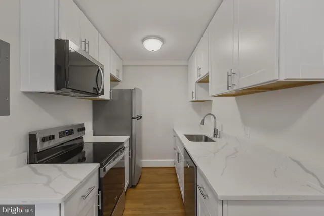 a kitchen that has a microwave and a sink
