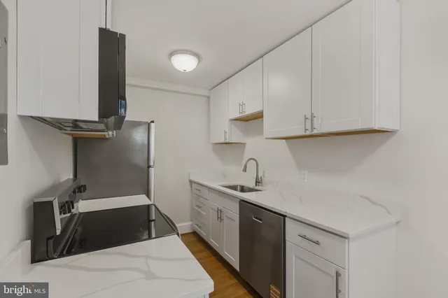 a kitchen with a sink and cabinets