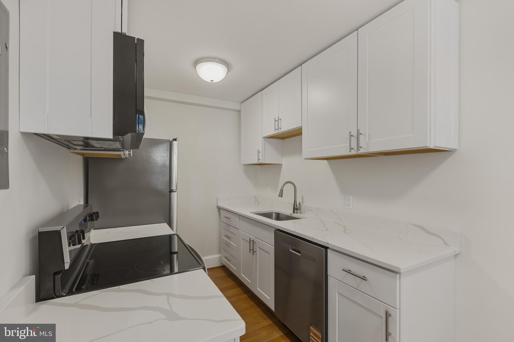 3051 Idaho Avenue Northwest, Unit 204 Washington, DC 20016 - Photo 12 of 27 a kitchen with a sink and cabinets