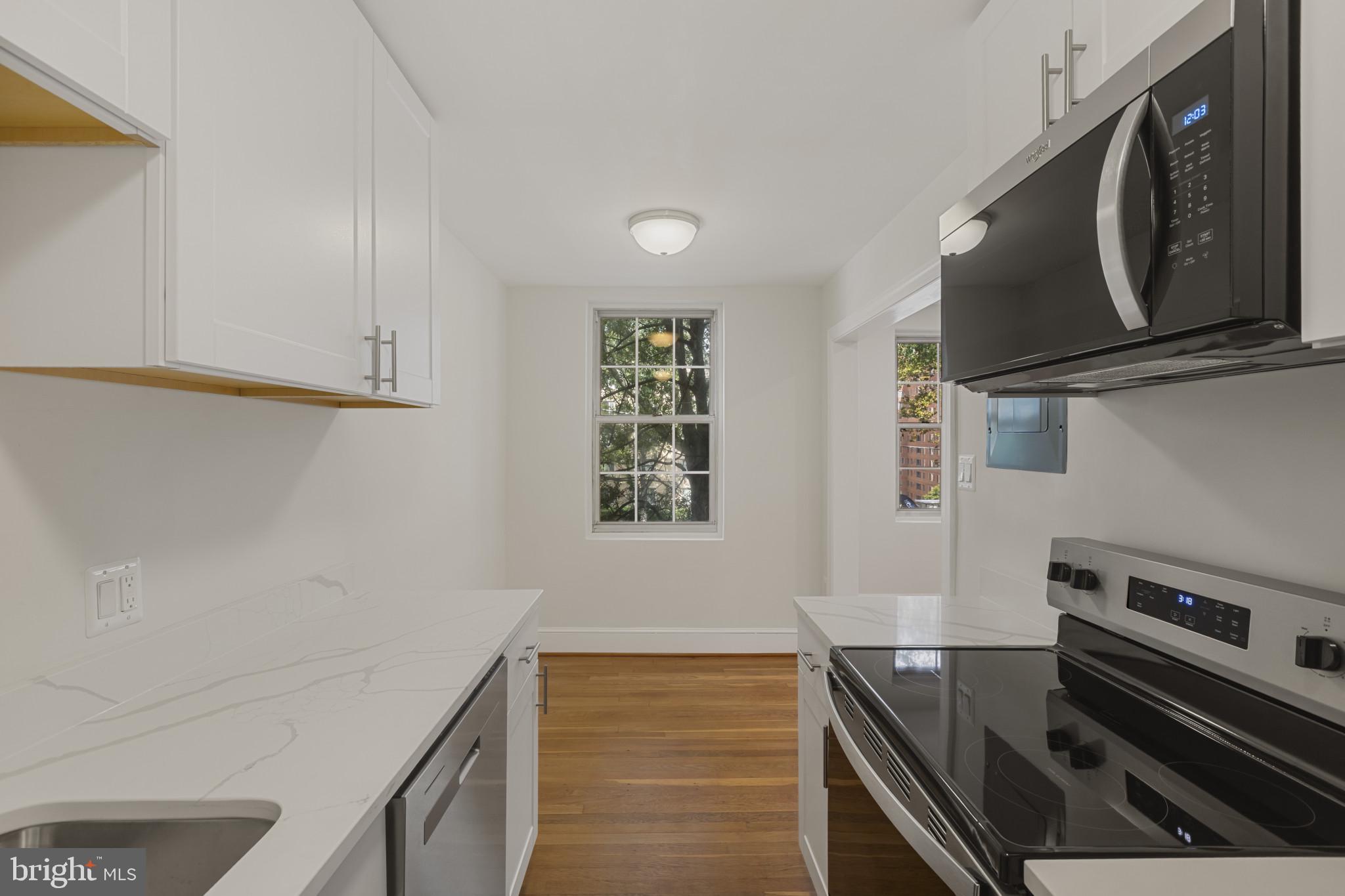 3051 Idaho Avenue Northwest, Unit 204 Washington, DC 20016 - Photo 13 of 27 a kitchen with a stove and a microwave