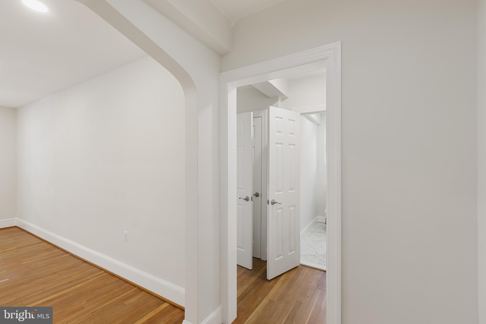 3051 Idaho Avenue Northwest, Unit 204 Washington, DC 20016 - Photo 14 of 27 a view of a hallway with wooden floor