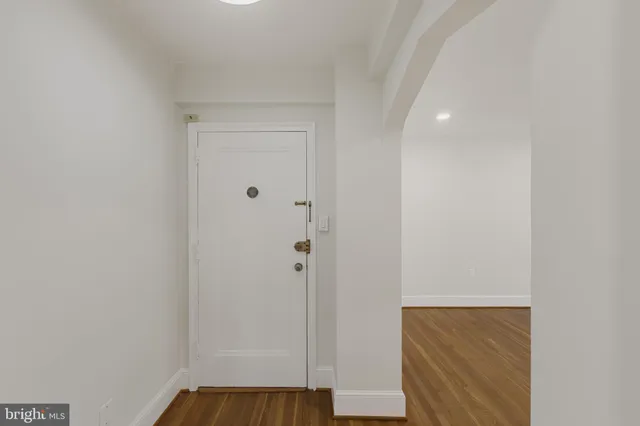 a view of front door with wooden floor