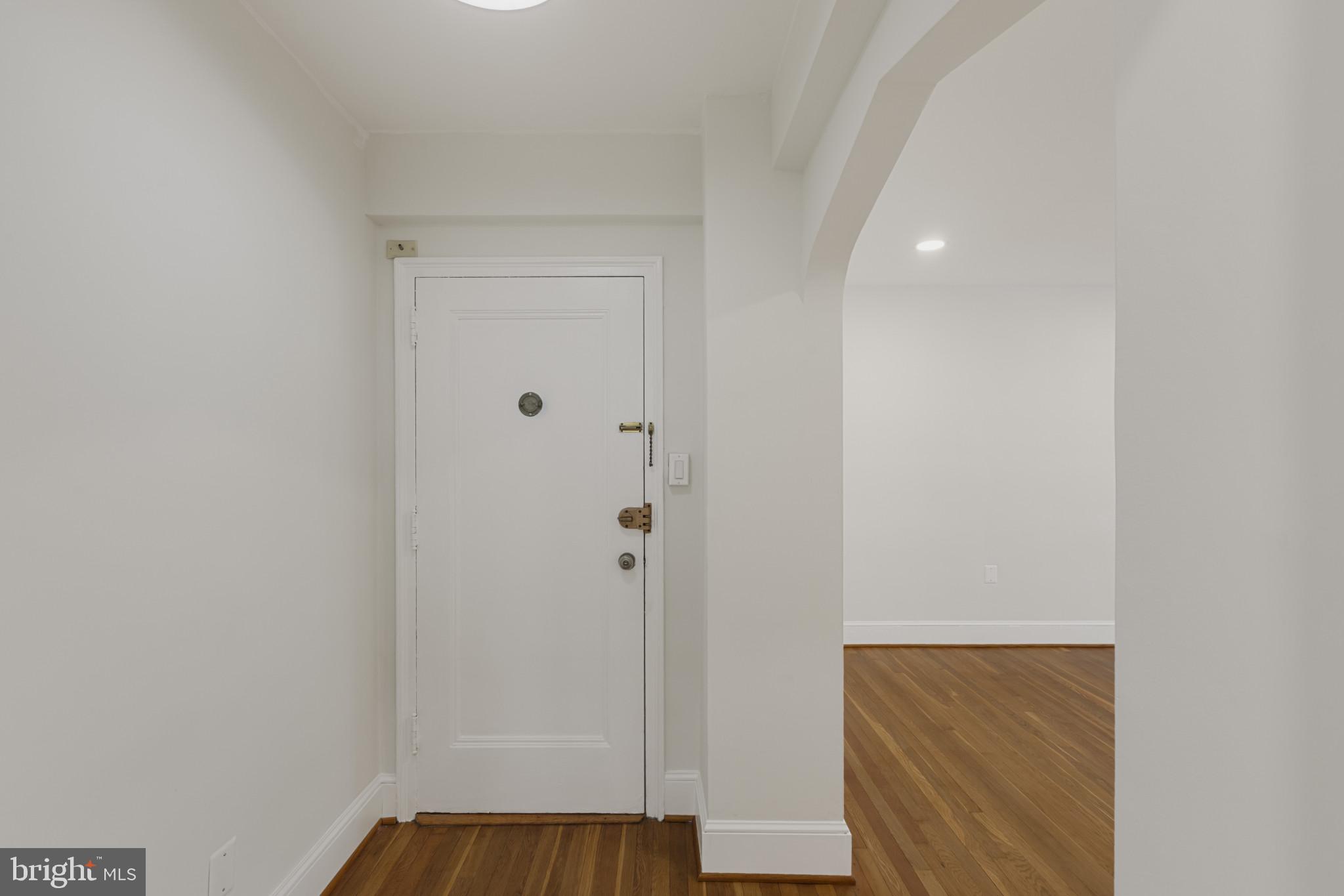 3051 Idaho Avenue Northwest, Unit 204 Washington, DC 20016 - Photo 15 of 27 a view of front door with wooden floor