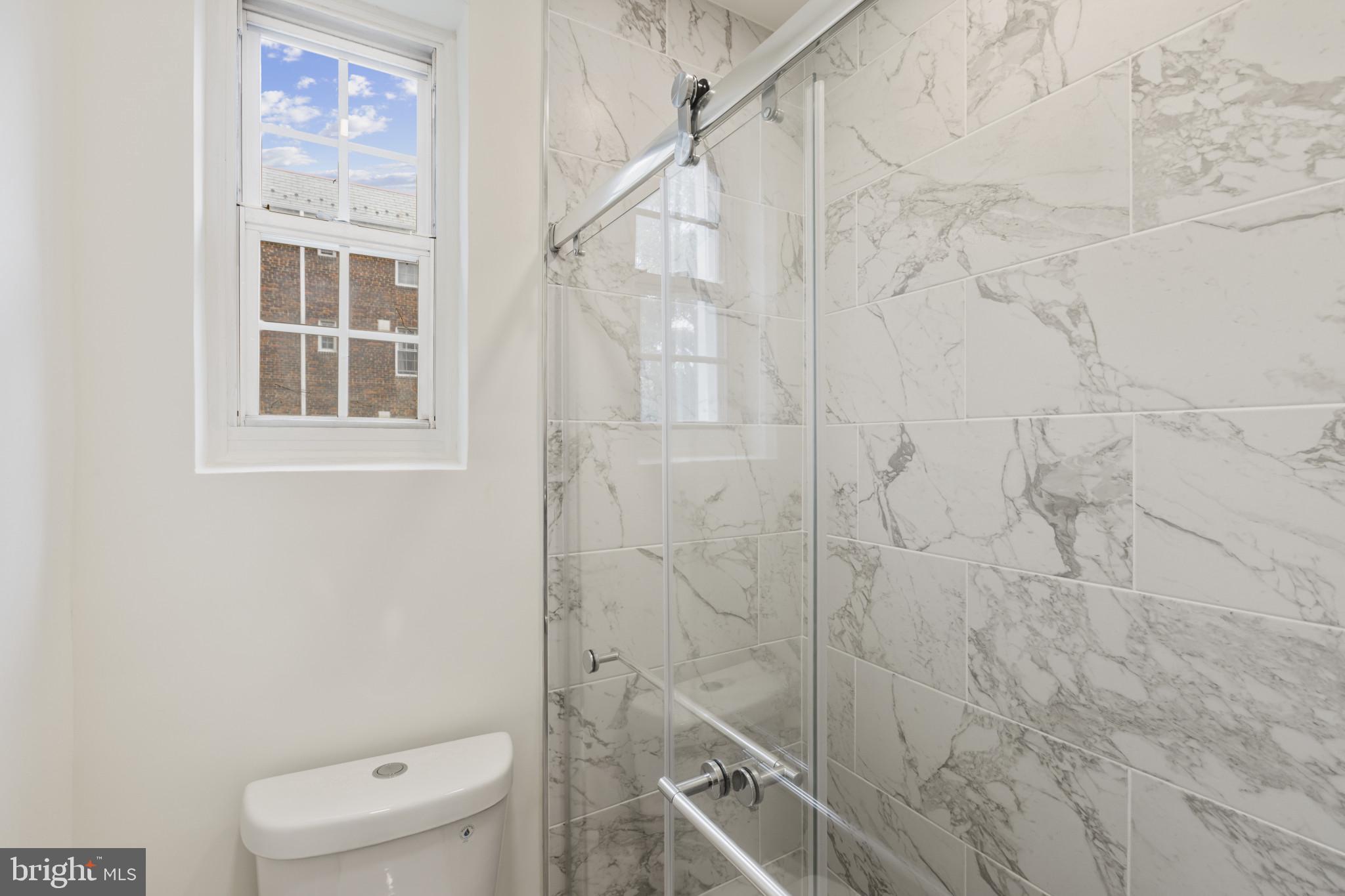 3051 Idaho Avenue Northwest, Unit 204 Washington, DC 20016 - Photo 19 of 27 a bathroom with a toilet and a shower