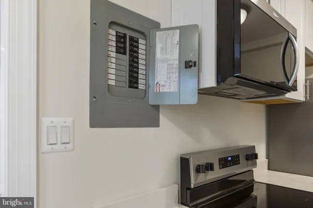 a bathroom with mirror and cabinets