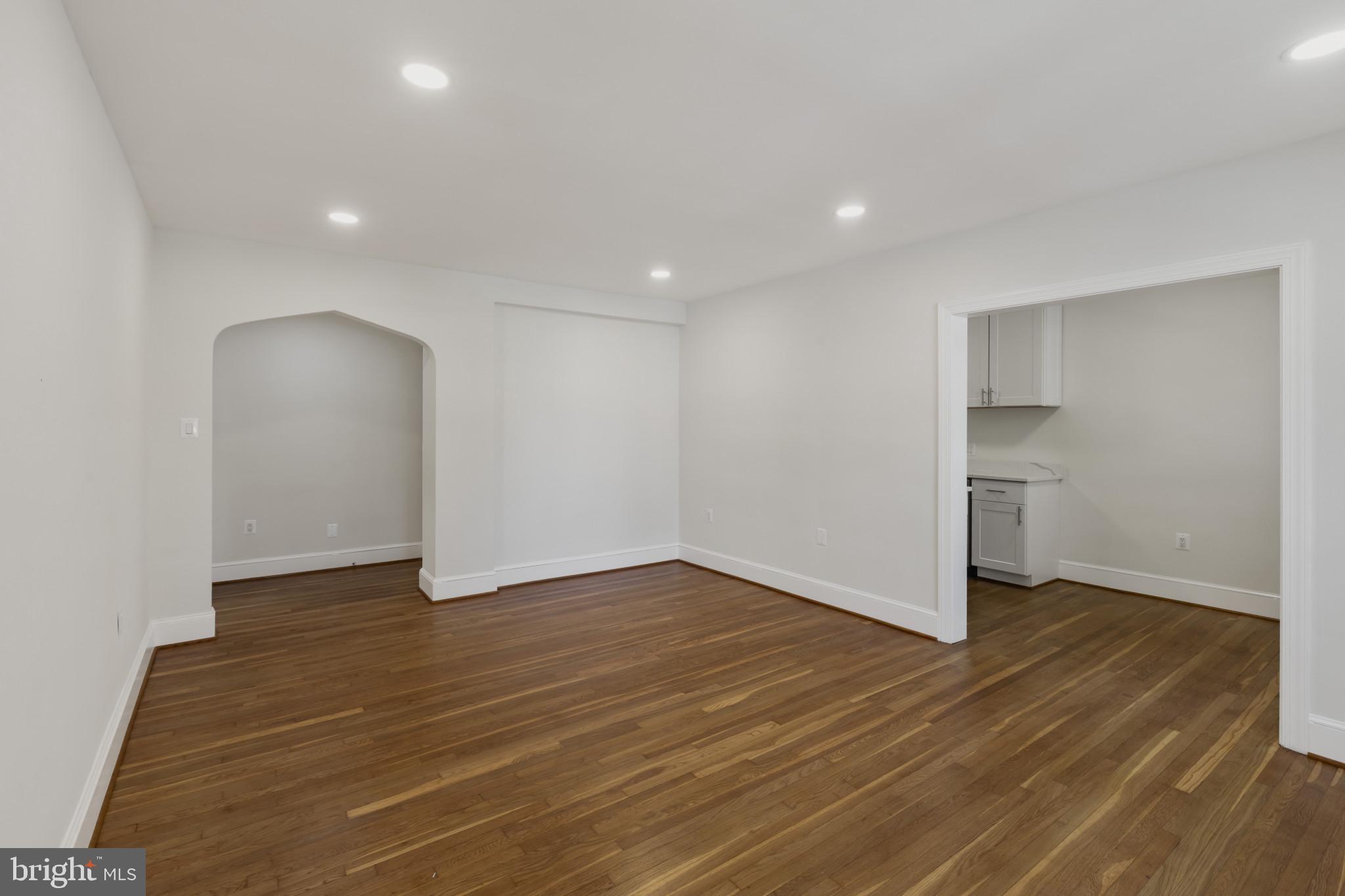 3051 Idaho Avenue Northwest, Unit 204 Washington, DC 20016 - Photo 6 of 27 a view of an empty room with wooden floor and a window