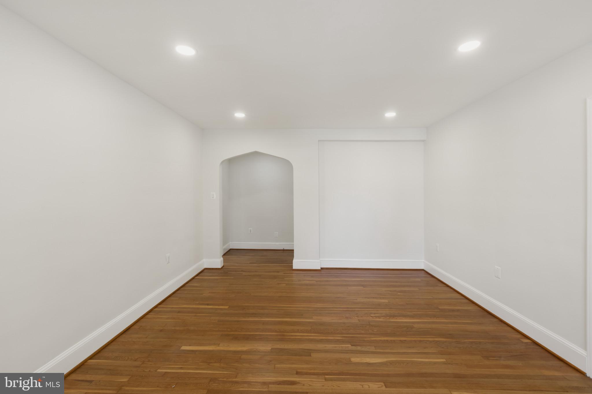 3051 Idaho Avenue Northwest, Unit 204 Washington, DC 20016 - Photo 7 of 27 a view of an empty room with wooden floor