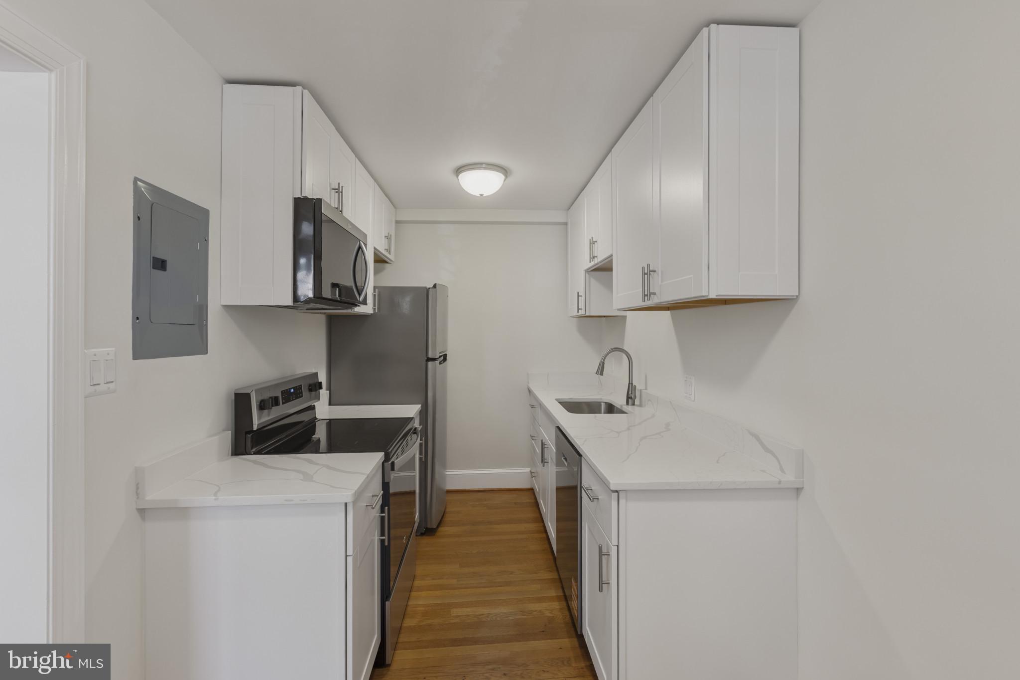 3051 Idaho Avenue Northwest, Unit 204 Washington, DC 20016 - Photo 9 of 27 a kitchen that has a sink a stove and a refrigerator
