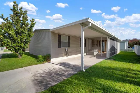 a view of a house with a yard and porch