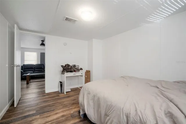 a spacious bedroom with a bed and a sink