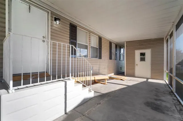 a backyard of a house with table and chairs
