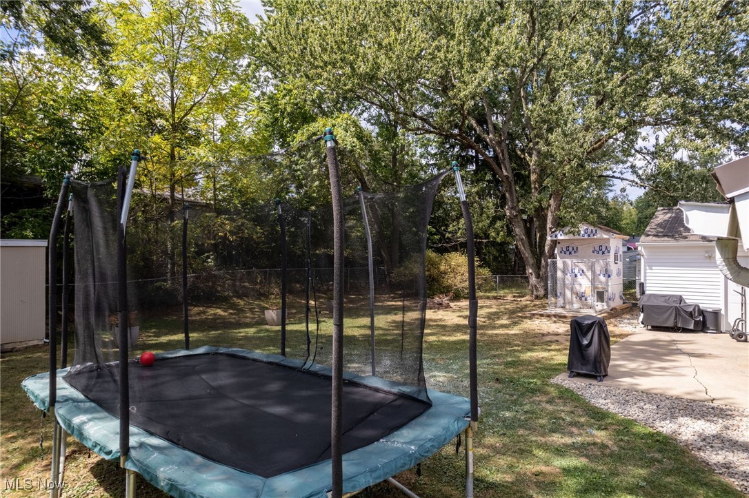 1418 Arcadia Road Kent, OH 44240 - Photo 20 of 27 View of yard with a trampoline, a patio, and a shed
