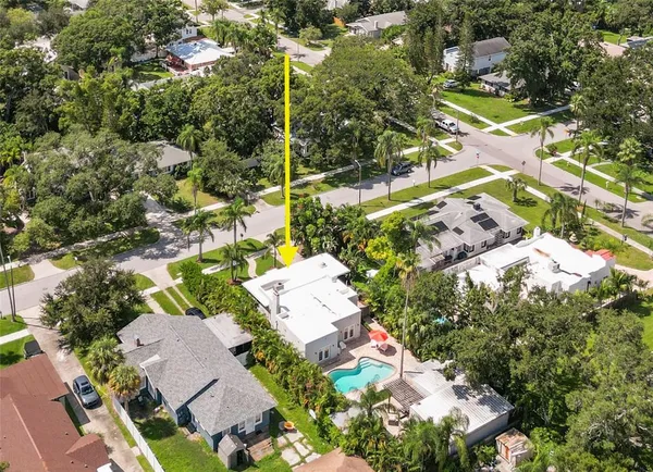 a view of a house with swimming pool and a yard