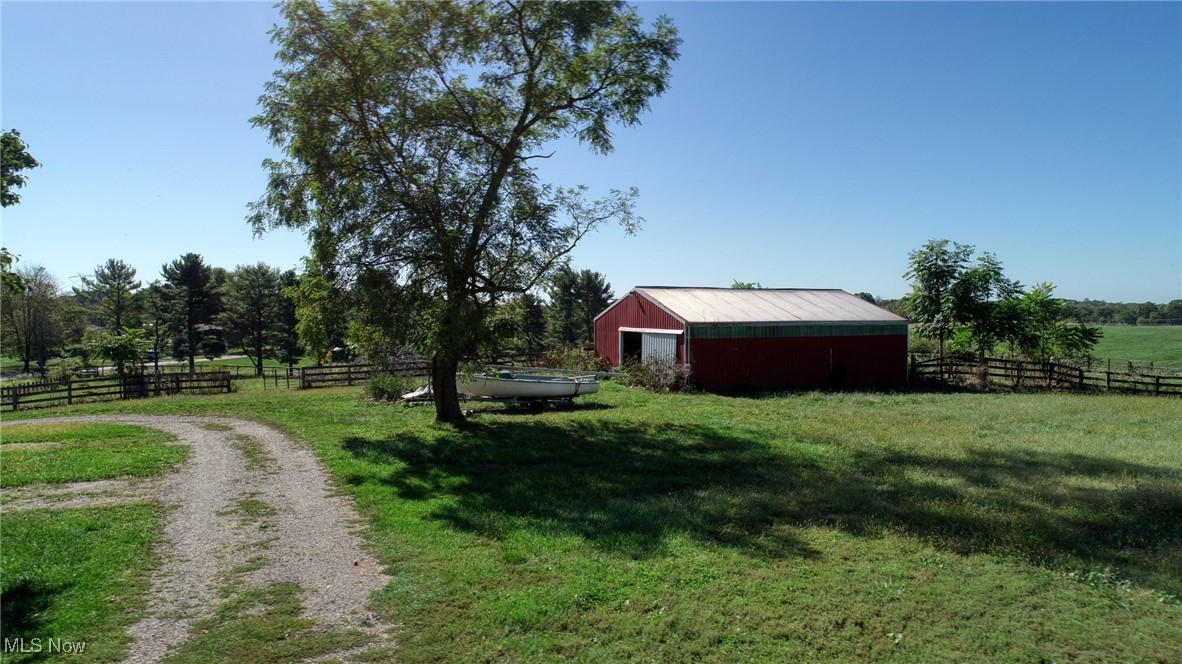 4896 High Hill Road Cambridge, OH 43725 - Photo 38 of 48 View of yard featuring a pole building, an outdoor structure, and a view of rural / pastoral area