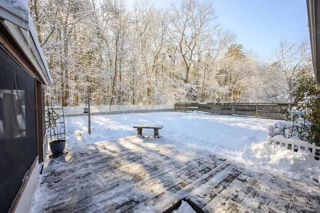 a view of a backyard with snow on the road