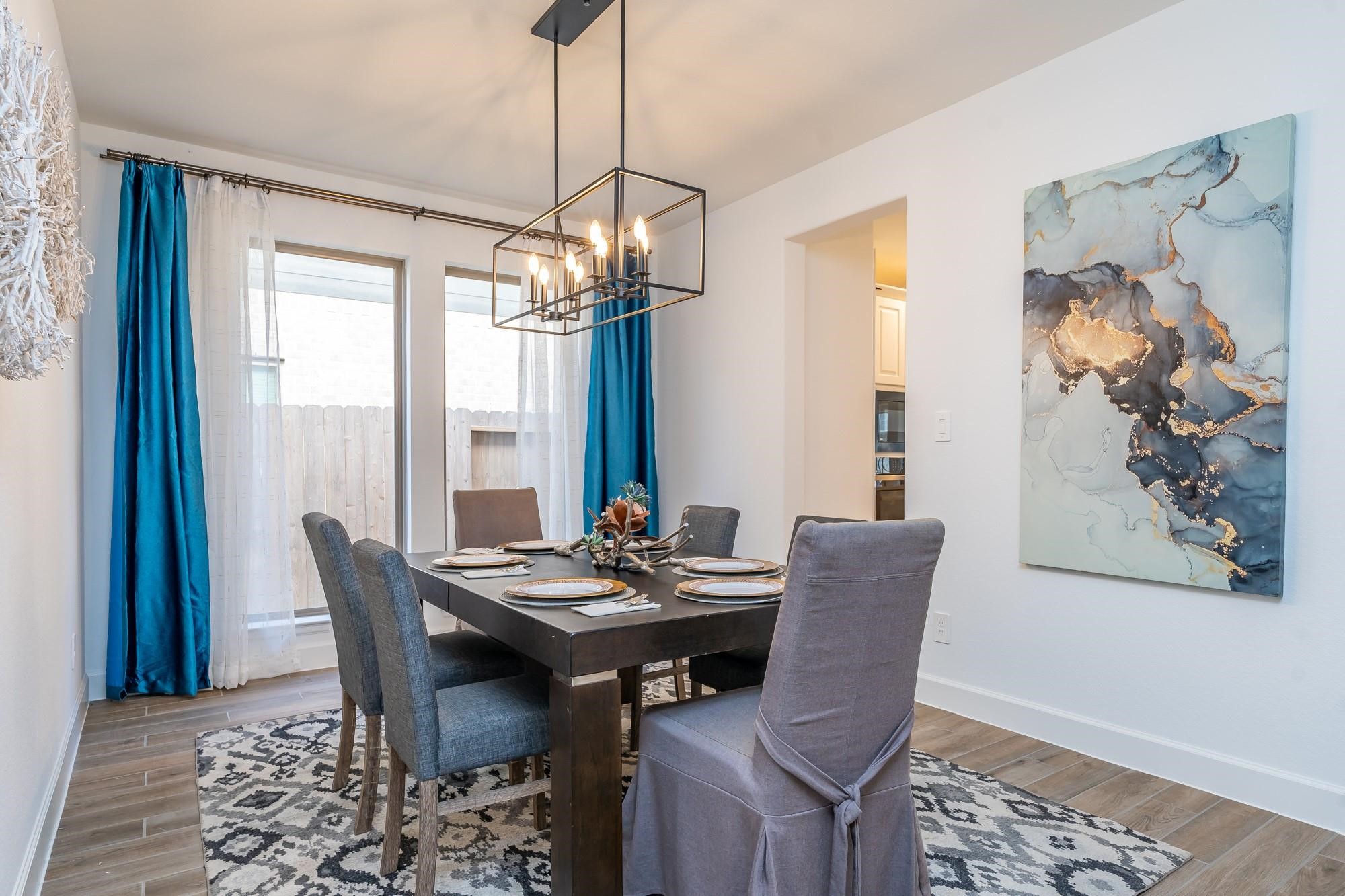 4118 Ana Ridge Lane Fulshear, TX 77441 - Photo 14 of 49 a dining room with furniture a chandelier and wooden floor