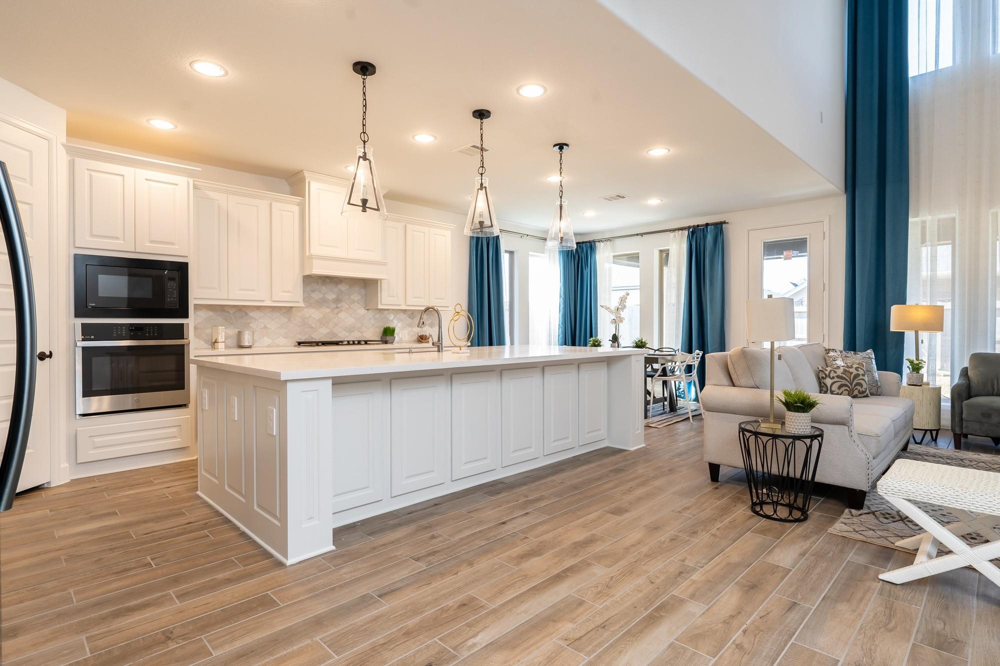 4118 Ana Ridge Lane Fulshear, TX 77441 - Photo 16 of 49 a large living room with stainless steel appliances kitchen island granite countertop a large window and a view of living room
