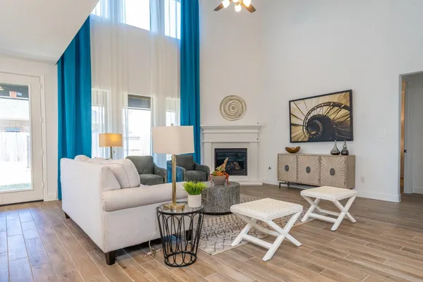 a living room with furniture a fireplace and a table