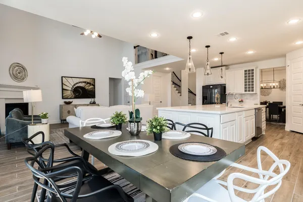 a kitchen with kitchen island white cabinets and stainless steel appliances