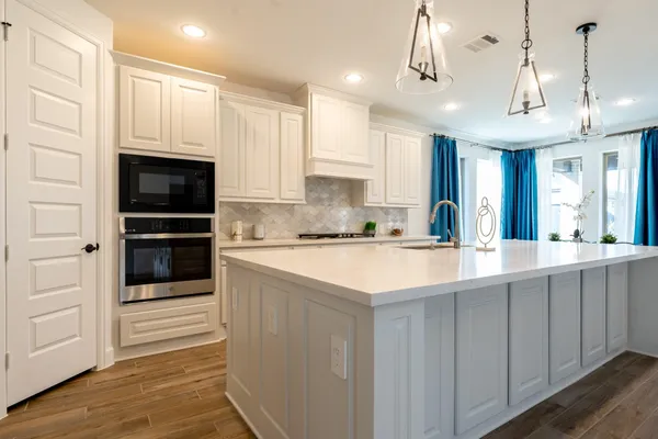 a kitchen with counter top space a sink cabinets and appliances