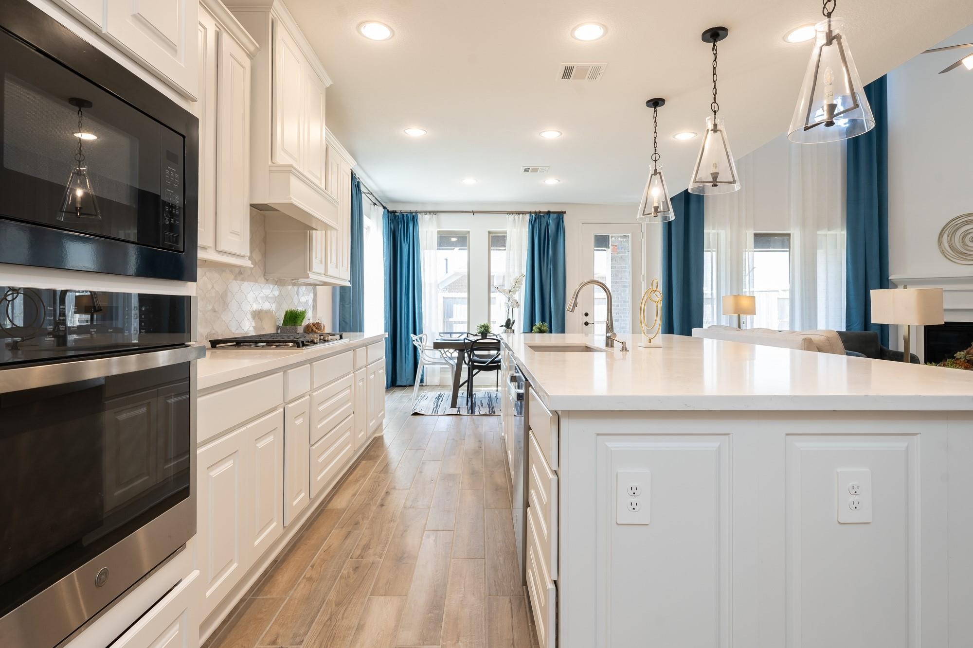 4118 Ana Ridge Lane Fulshear, TX 77441 - Photo 25 of 49 a kitchen with counter top space a sink cabinets and appliances