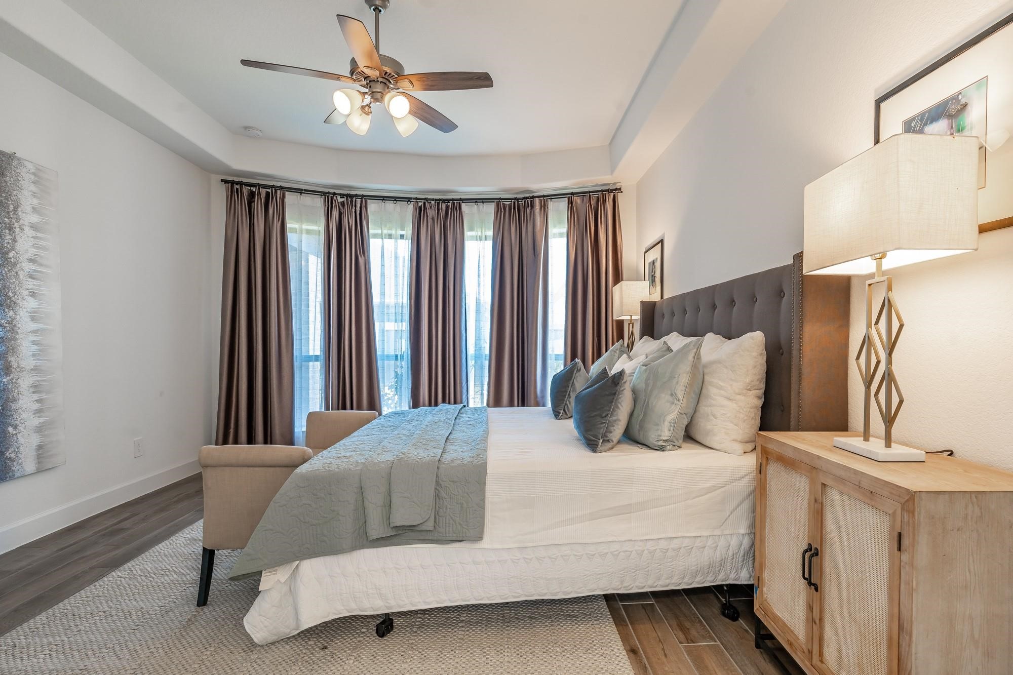 4118 Ana Ridge Lane Fulshear, TX 77441 - Photo 28 of 49 a bedroom with a large bed and a chandelier