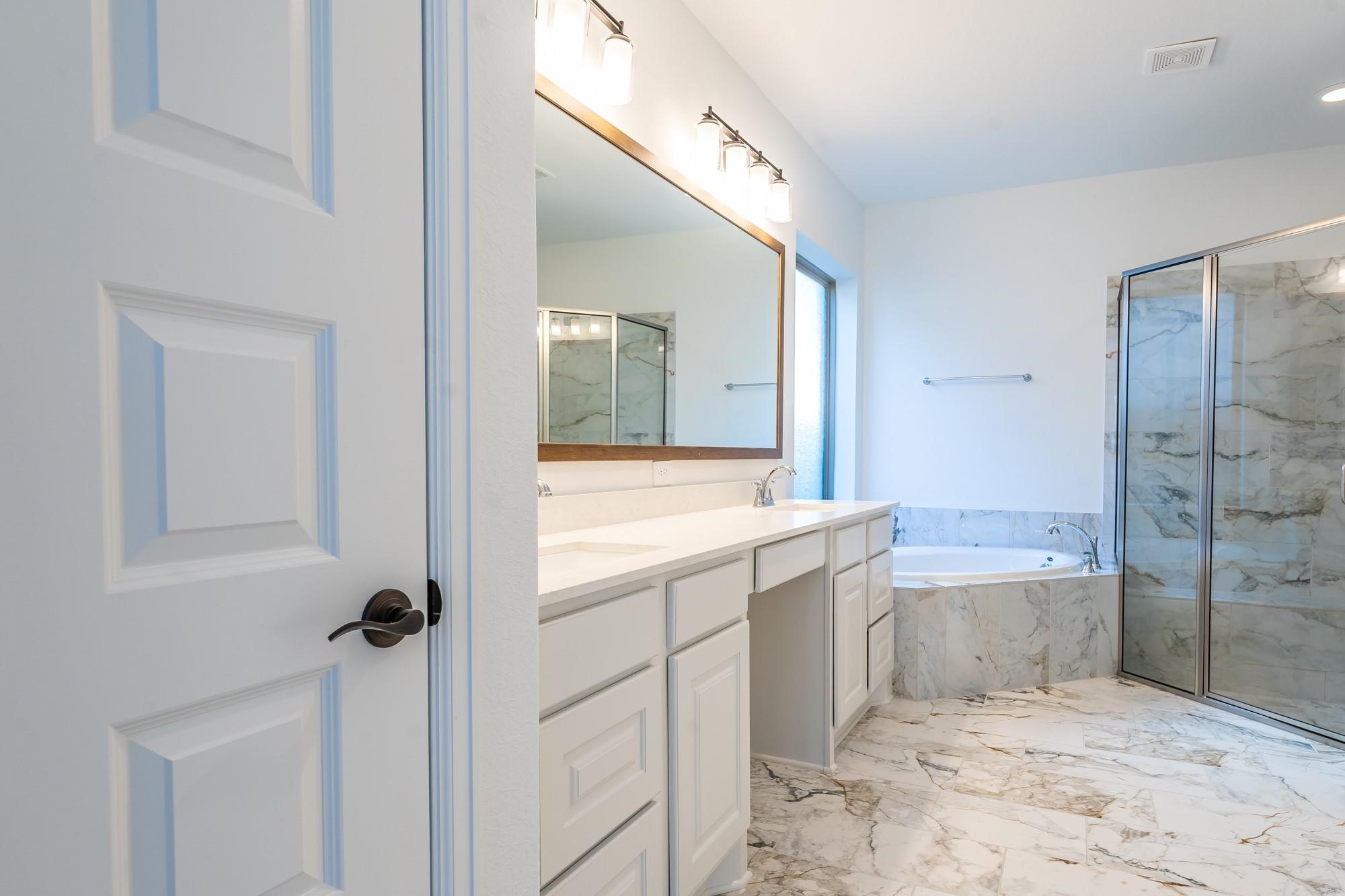 4118 Ana Ridge Lane Fulshear, TX 77441 - Photo 29 of 49 a bathroom with a granite countertop sink a mirror and shower